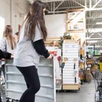 Participants move a shelf at Restore.